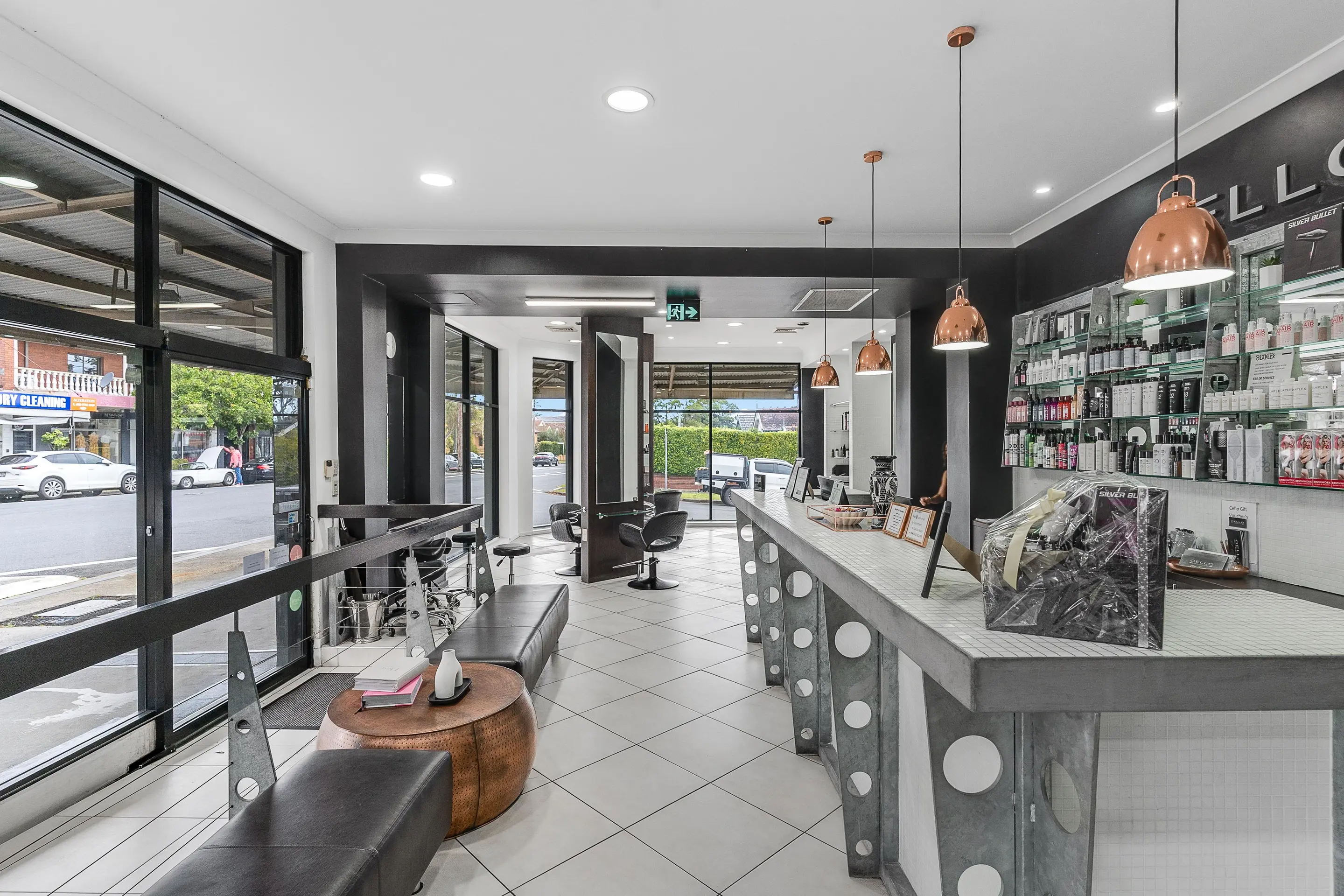 The front of Cello Hairdressers, looking from the reception desk down the salon to the street windows.